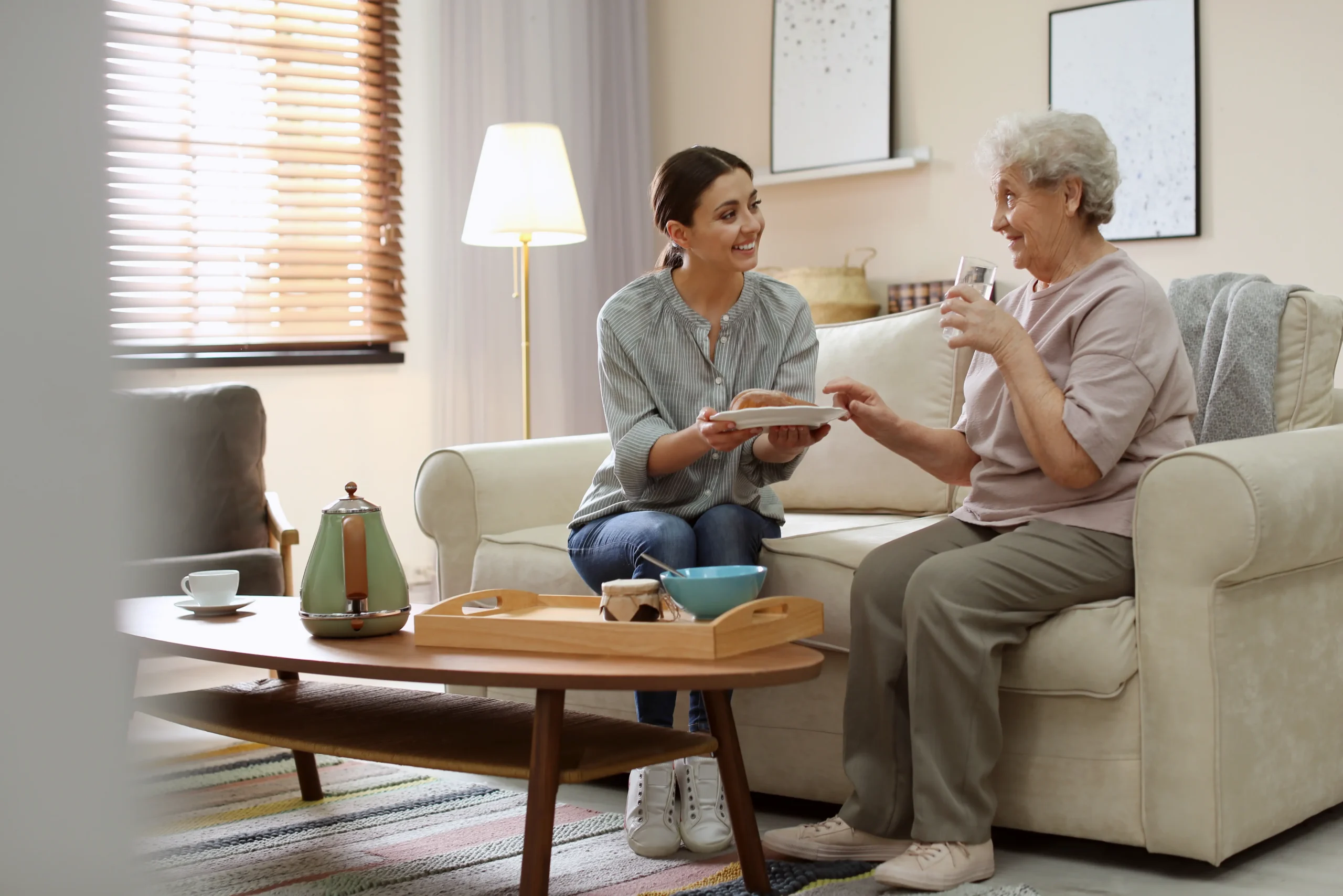 Senior residents socializing in living room at Franklin Johns Creek